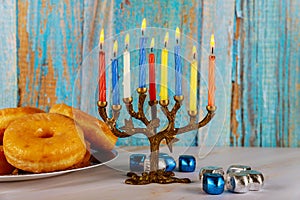 Jewish holiday Hanukkah with menora, donuts and dreidels photo