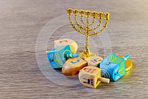 jewish holiday Hanukkah with wooden dreidels colection spinning top and chocolate coins on the table