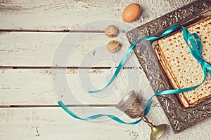 Jewish holiday Passover background with matzoh on wooden white table. View from above.