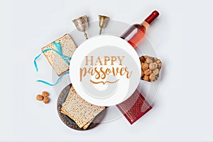 Jewish holiday Passover banner design with wine, matza and seder plate on white background. View from above. photo