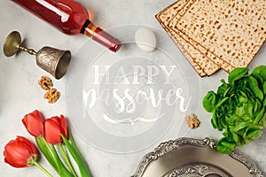 Jewish holiday Passover Pesah greeting card with seder plate, matzoh and red wine bottle.