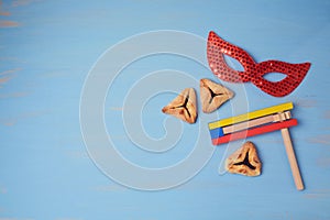 Jewish holiday purim background with carnival mask and hamantaschen cookies.