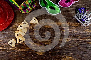 Jewish holiday Purim with carnival mask and hamantaschen cookies. Flat lay