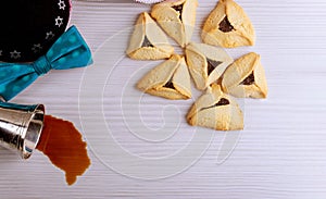 Jewish holiday Purim with carnival mask and hamantaschen cookies red kosher wine