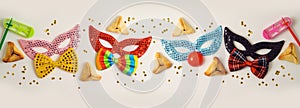 Jewish holiday Purim celebration background with traditional cookies and carnival mask