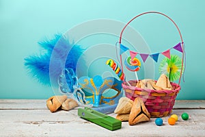 Jewish holiday Purim concept with hamantaschen cookies or hamans ears and carnival mask