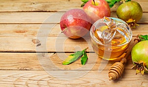 Jewish holiday Rosh Hashana background with honey jar, apple and pomegranate