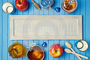 Jewish holiday Rosh Hashana background with wooden board, honey and apples on table. View from above. photo