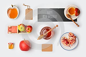 Jewish holiday Rosh Hashana mock up template with honey jar,apples and pomegranate. View from above.