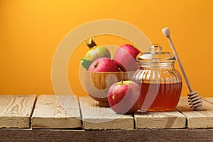 Jewish holiday Rosh Hashana (New Year) celebration with honey jar and apples photo