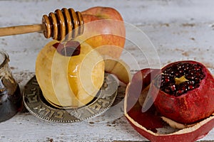 Jewish Holiday Rosh hashanah honey and apples with pomegranate