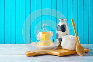 Jewish holiday Shavuot background with milk, cottage cheese and butter on wooden table