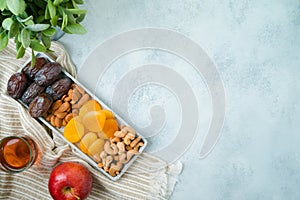 Jewish holiday Tu Bishvat modern background with dried dates, fruits and nuts. Top view with copy space