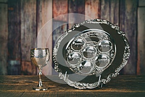 Jewish holidays Passover Pesach matzah and a silver cup full of wine with a traditional blessing