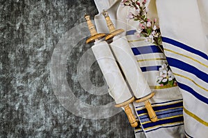 Jewish holidays, during prayer items kippa with prayer shawl tallit on torah scroll