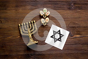 Jewish Kippah Yarmulkes hats, star of David and menorah on wooden table. Top view