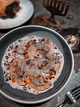Jewish kreplach dumplings in sauce with vegetables and spices photo