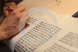 Jewish man with beard writing on a parchment scroll. Photo taken on: December 30th,2015