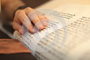 Jewish man with beard writing on a parchment scroll. Photo taken on: December 30th,2015