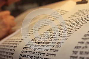 Jewish man with beard writing on a parchment scroll. Photo taken on: December 30th,2015