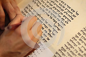 Jewish man with beard writing on a parchment scroll. Photo taken on: December 30th,2015