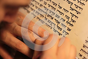 Jewish man with beard writing on a parchment scroll. Photo taken on: December 30th,2015