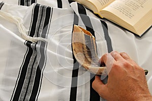 Jewish man hands next to Prayer book, praying, next to tallit. Jewish traditional symbols. Rosh hashanah jewish New Year holiday