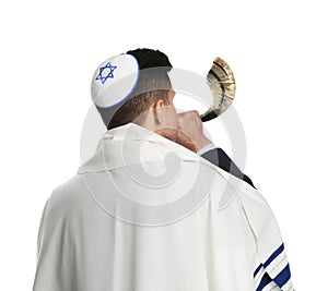 Jewish man with kippah and tallit blowing shofar on white background. Rosh Hashanah celebration