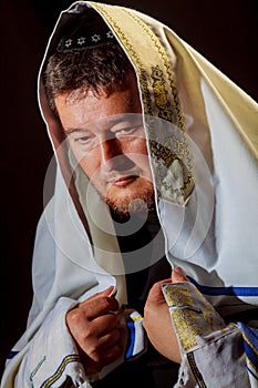 Jewish man in wrapped talit pray religious orthodox Jew with prays photo