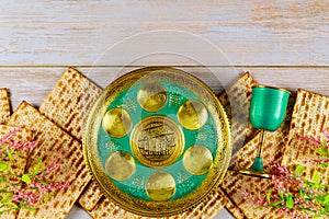Jewish matzah, kiddush and seder with text in hebrew. English translation egg, bone, herbs, karpas, chazeret and charoset