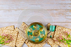 Jewish matzah, kiddush and seder with text in hebrew egg, bone, herbs, karpas, chazeret and charoset. Passover concept