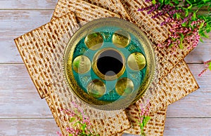 Jewish matzah, kiddush and seder with text in hebrew egg, bone, herbs, karpas, chazeret and charoset. Passover concept