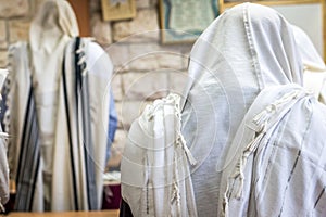 Jewish men praying in a synagogue with Tallit