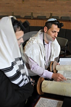 Jewish Men Reading and Praying from a Torah Scroll