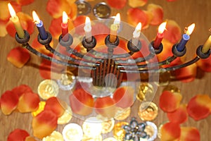 Jewish menorah with lighted candles and chocolate coins Hanukkah and Judaic holiday symbol