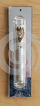 A Jewish Mezuzah which is mounted on the side post of a door way.