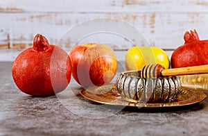 A jewish new year with honey for the apple and pomegranate holiday of Yom Kippur and Rosh Hashanah