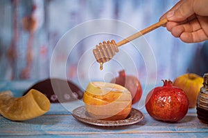 A jewish new year with honey for the apple and pomegranate holiday of Yom Kippur and Rosh Hashanah