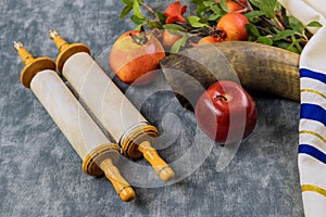 Jewish New Year symbols with shofar glass honey jar, fresh apples, and pomegranates celebrating Rosh Hashanah