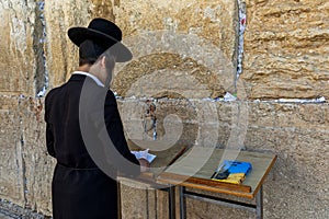 Jewish orthodox man praying at Western Wall in Jerusalem, Israel.