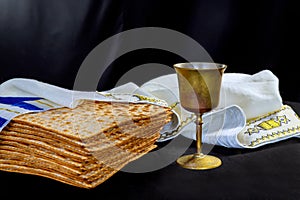 Jewish pesach attributes holiday with cup kosher wine, flatbread matzah at a Passover