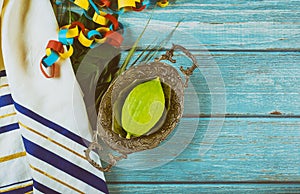 Jewish ritual festival of Sukkot in the jewish religious symbol Etrog, lulav, hadas, arava tallit praying book kippah and shofar photo