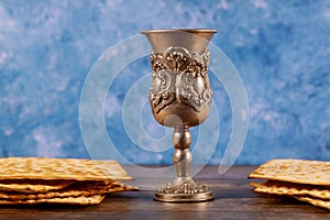 Jewish silver cup with wine with matzos. Passover concept