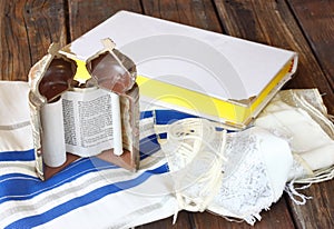 Jewish torah and talit on wooden table