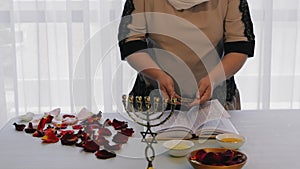 A Jewish woman conducts the pre-wedding ceremonies of a rich life with her husband reciting a blessing on shekels