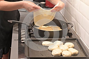 Jewish woman hands preparing traditional Moroccan Moufleta at home