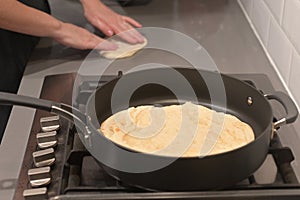 Jewish woman hands preparing traditional Moroccan Moufleta at home