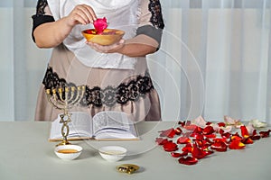 A Jewish woman performs superstition conspiracies before the wedding with rose petals to be the most beautiful for her