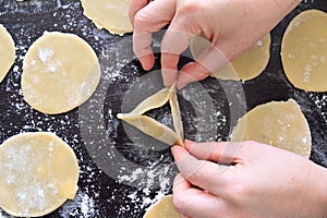 Jewish woman preparing the first Hamantash cookie for Purim Jewish holiday