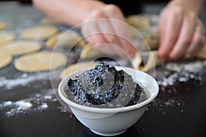 Jewish woman preparing Hamantash cookies with Poppy seeds cream